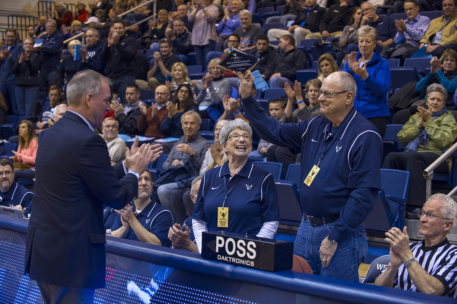 John and Brenda Riseland are applauded by WWU AD Steve Card and former AD Lynda Goodrich (in the background).